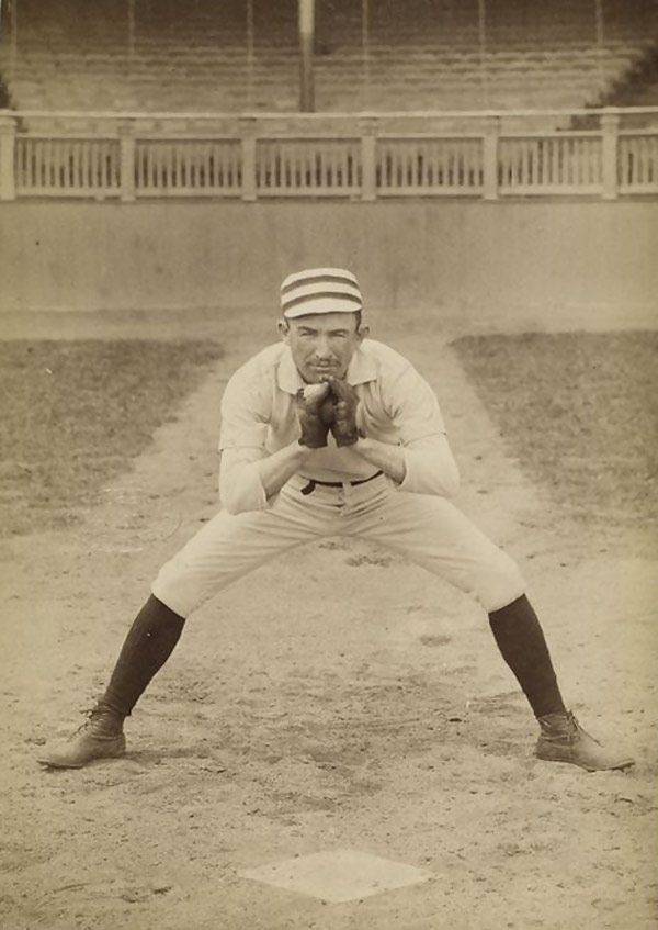 Baseball history photo:  Unidentified 19th century baseball player assuming catcher's position pose. Note the use of two gloves and the pre-1900 square home plate.  Click photo to return to previous page.