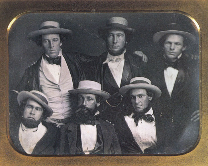 Baseball history photo: A photo purported to be of the New York Knickerbockers Baseball Club circa 1847. The only positively identified member of the Knickerbockers Base Ball Club in this photo is Alexander Cartwright (top center). Harold Peterson, author of “The Man Who Invented Baseball”, has conjectured that the clean-shaven fellow at the top left may be Cartwright's younger brother, Alfred. Indeed, the two young men are similar in appearance and each has his arm around the other's shoulder. (According to club records, Alfred was never a member of the Knickerbocker Base Ball Club.) Some have proposed that the individual at lower left is Duncan Curry, first Knickerbocker club president. This identification is based solely on a photo of a much older Curry on p. 54 of Albert Spalding's “America's National Game.” This identification is tenuous at best. The cigar-smoking chap at lower center bears some resemblance to Daniel “Doc” Adams, though the conjecture is by no means definitive. In short, though it is not unlikely that this image is of six members of the Knickerbockers, it is by no means definitively a Knickerbocker team photo.  Click photo to return to previous page.
